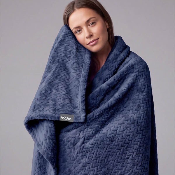 A woman wrapped in a chevron microplush blanket