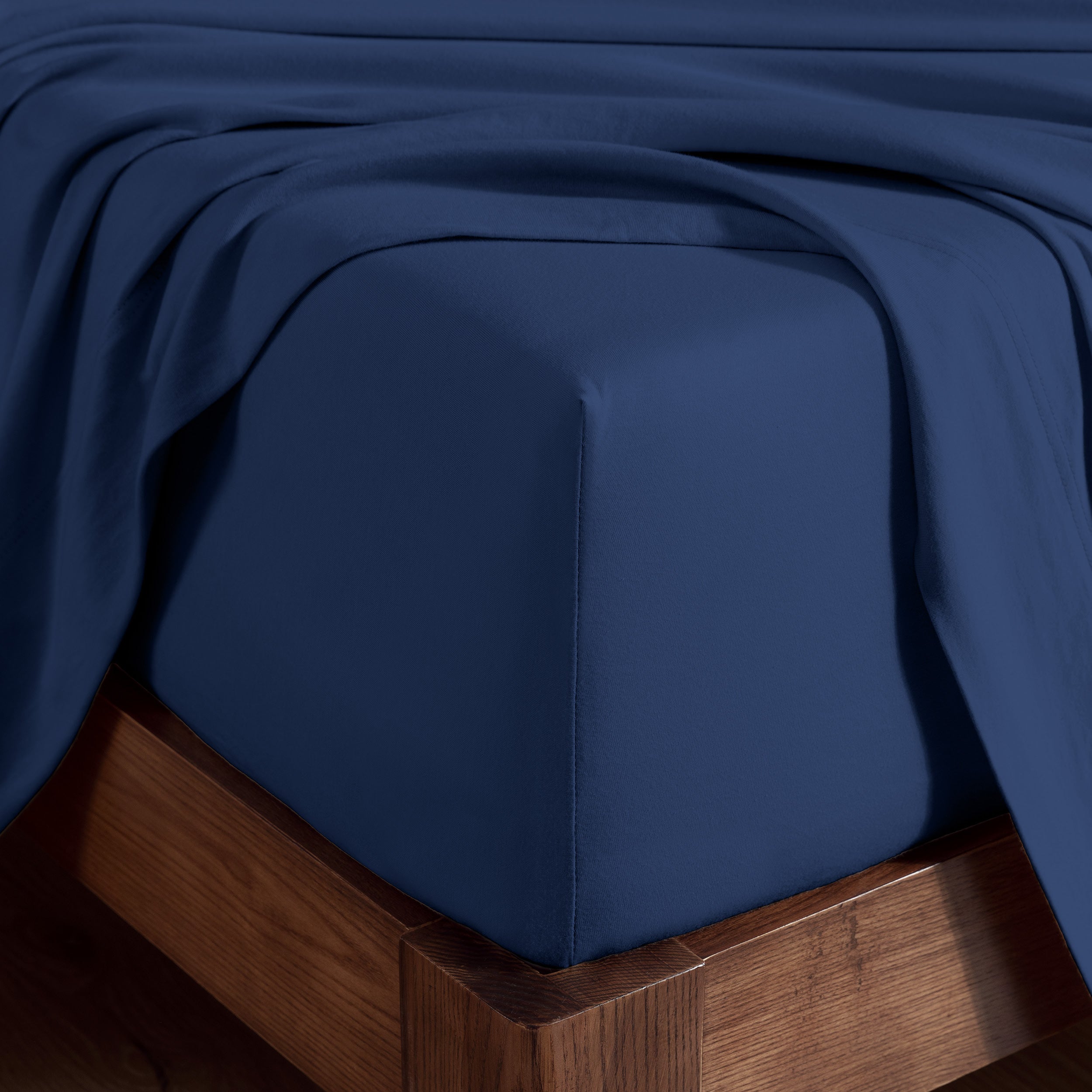 Organic cotton jersey sheet set on a wooden bed frame