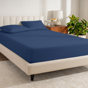 A bed made with a percale fitted sheet