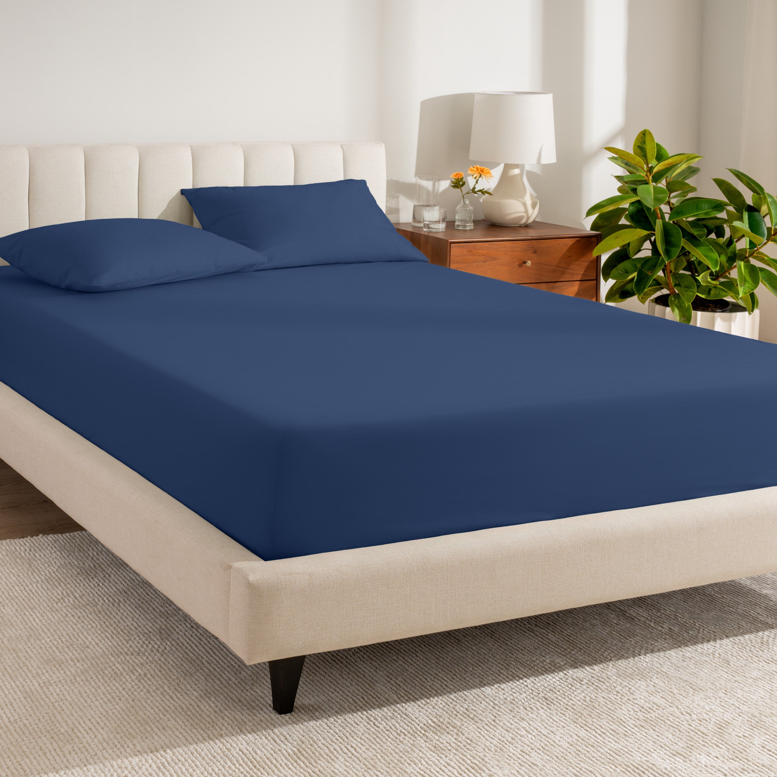 A bed made with a percale fitted sheet