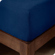 Close up of the corner of a mattress with a fleece fitted sheet on it
