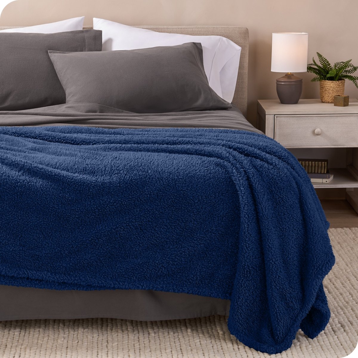 A double sided sherpa blanket on a bed