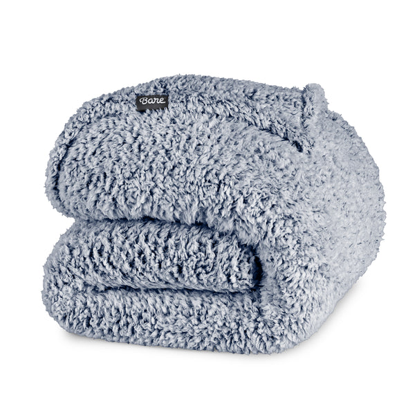 Folded sherpa blanket with a Bare label on a white background