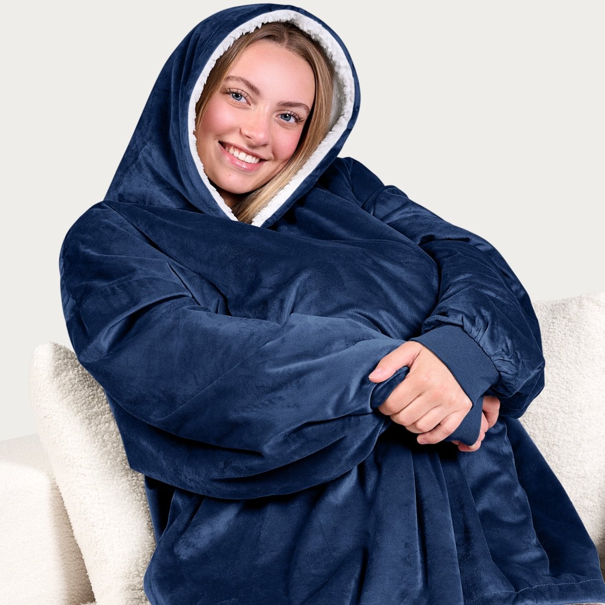An adult with a sherpa wearable blanket on