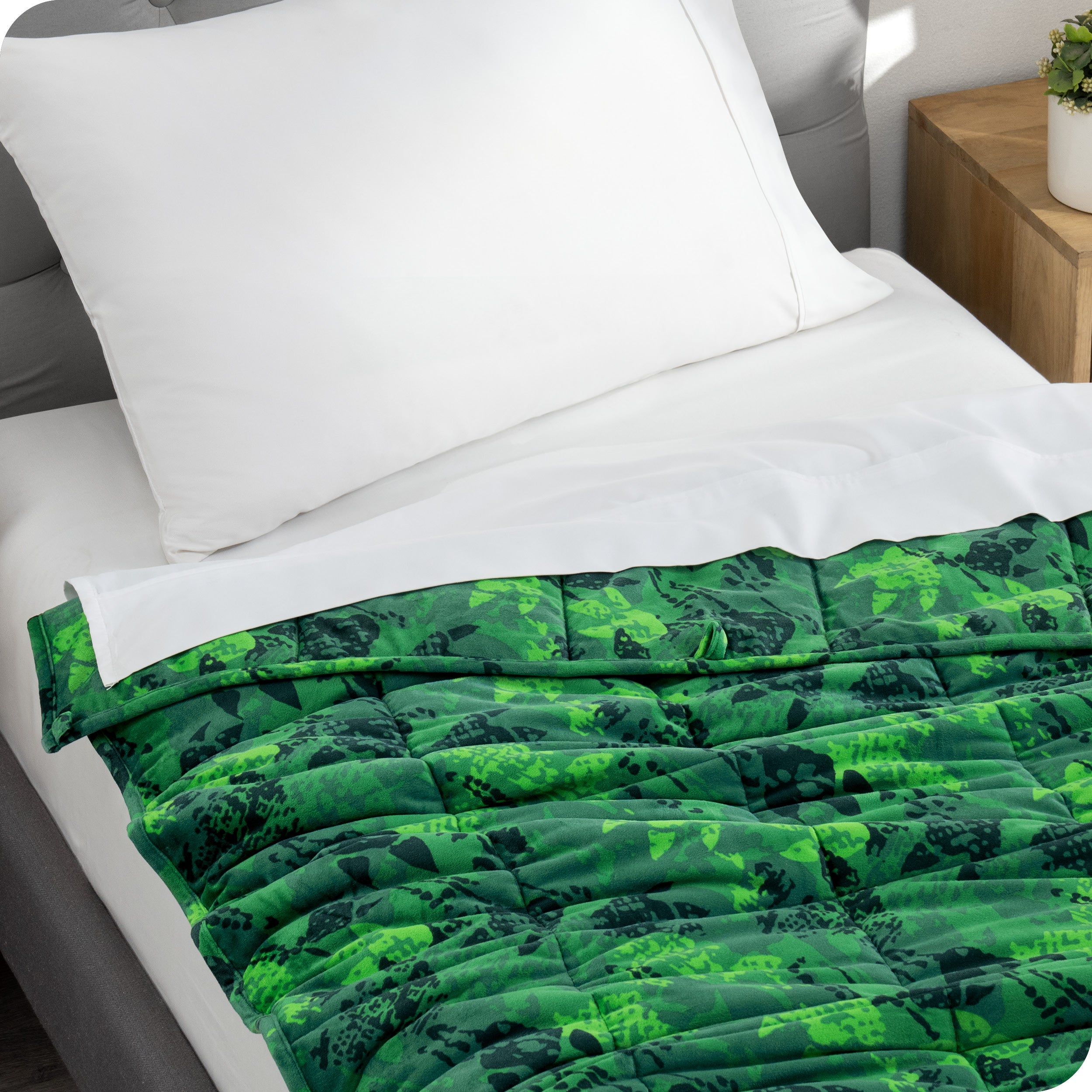 A weighted blanket laid out on a bed.