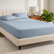 A bed made with a percale fitted sheet