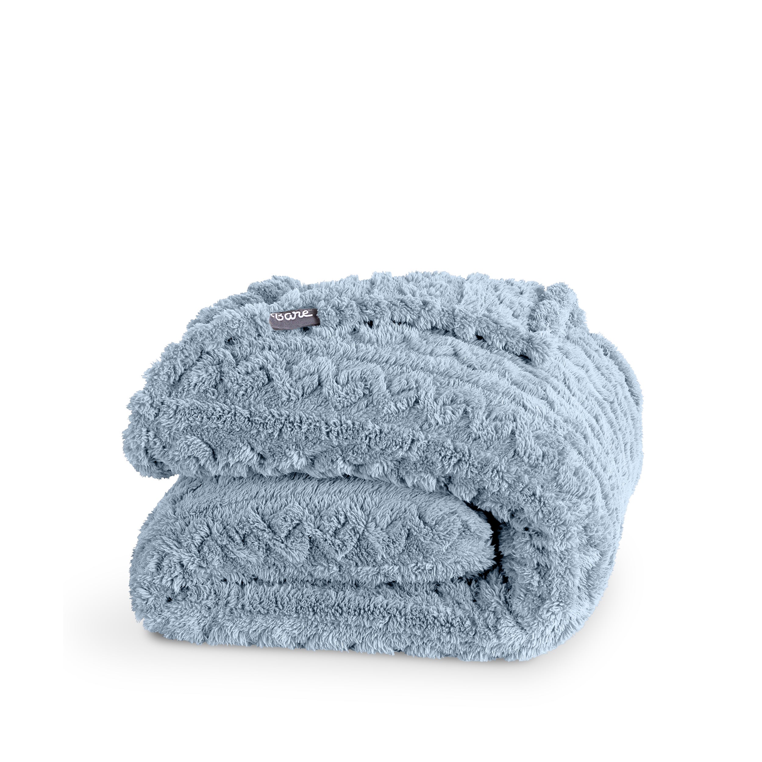 A cable knit sherpa blanket folded neatly