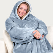 An adult with a sherpa wearable blanket on