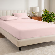 A bed made with a percale fitted sheet