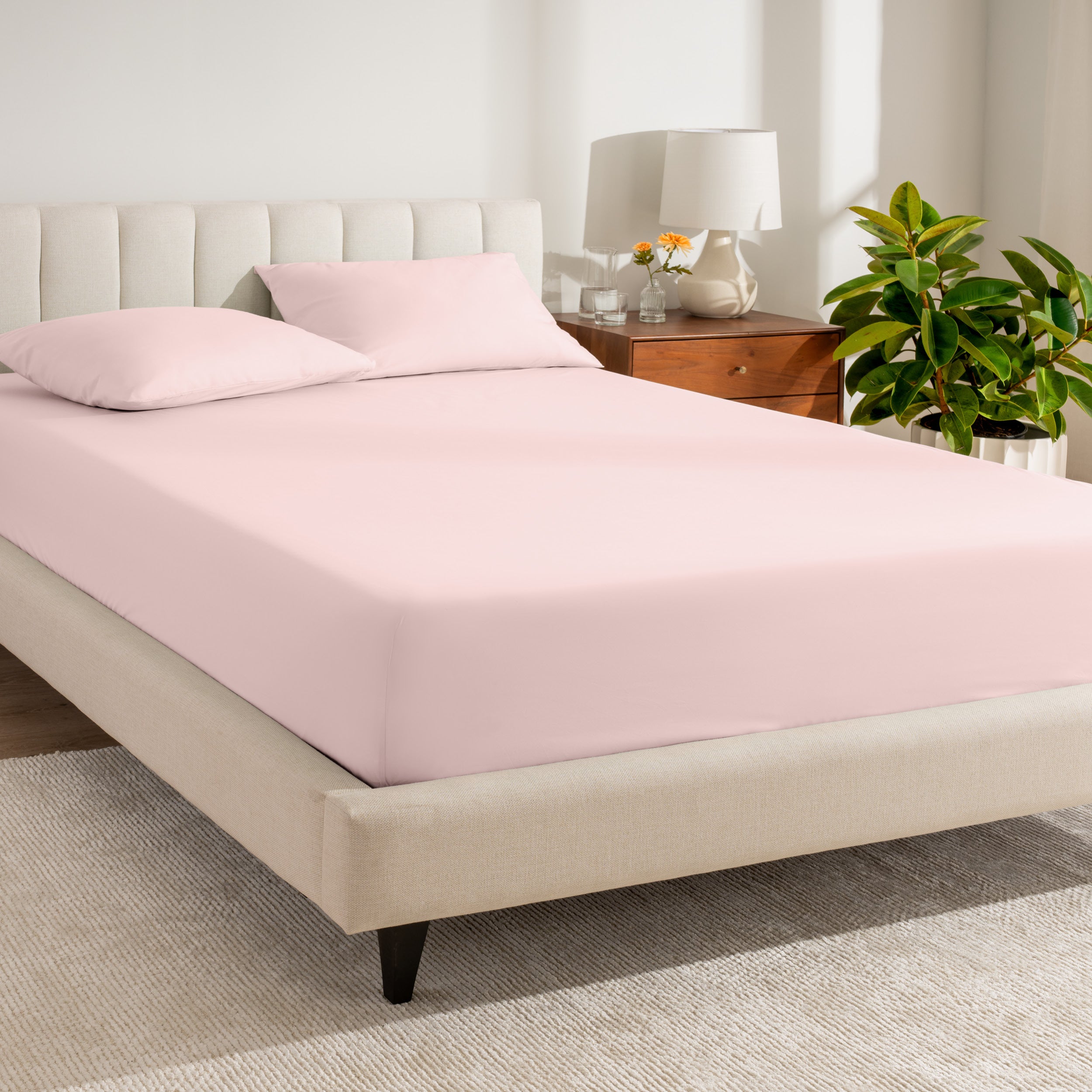 A bed made with a percale fitted sheet
