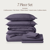 7-piece percale bedding set with pillowcases, flat sheet, fitted sheet, duvet cover, and pillow shams on a light background.