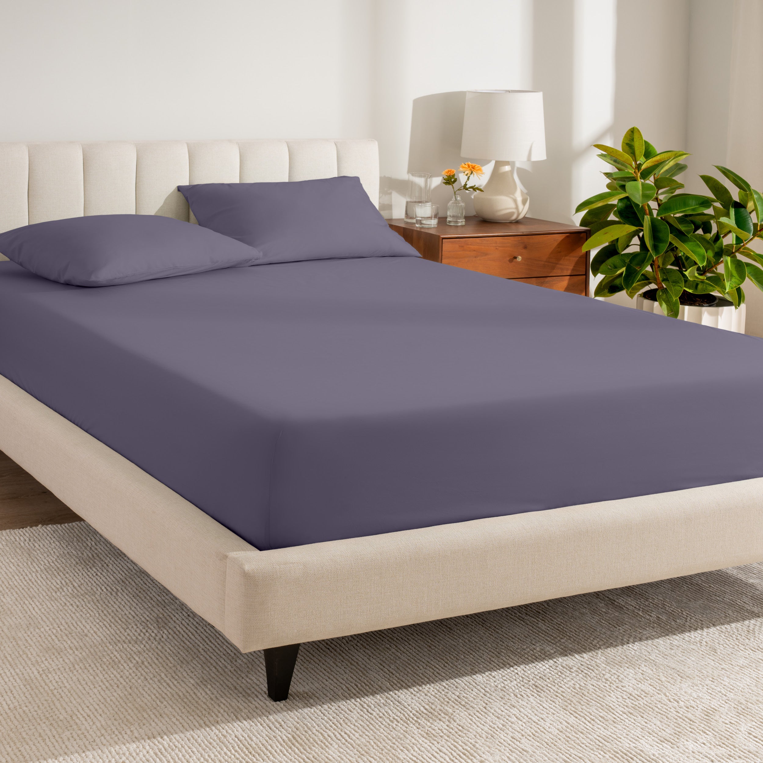 A bed made with a percale fitted sheet