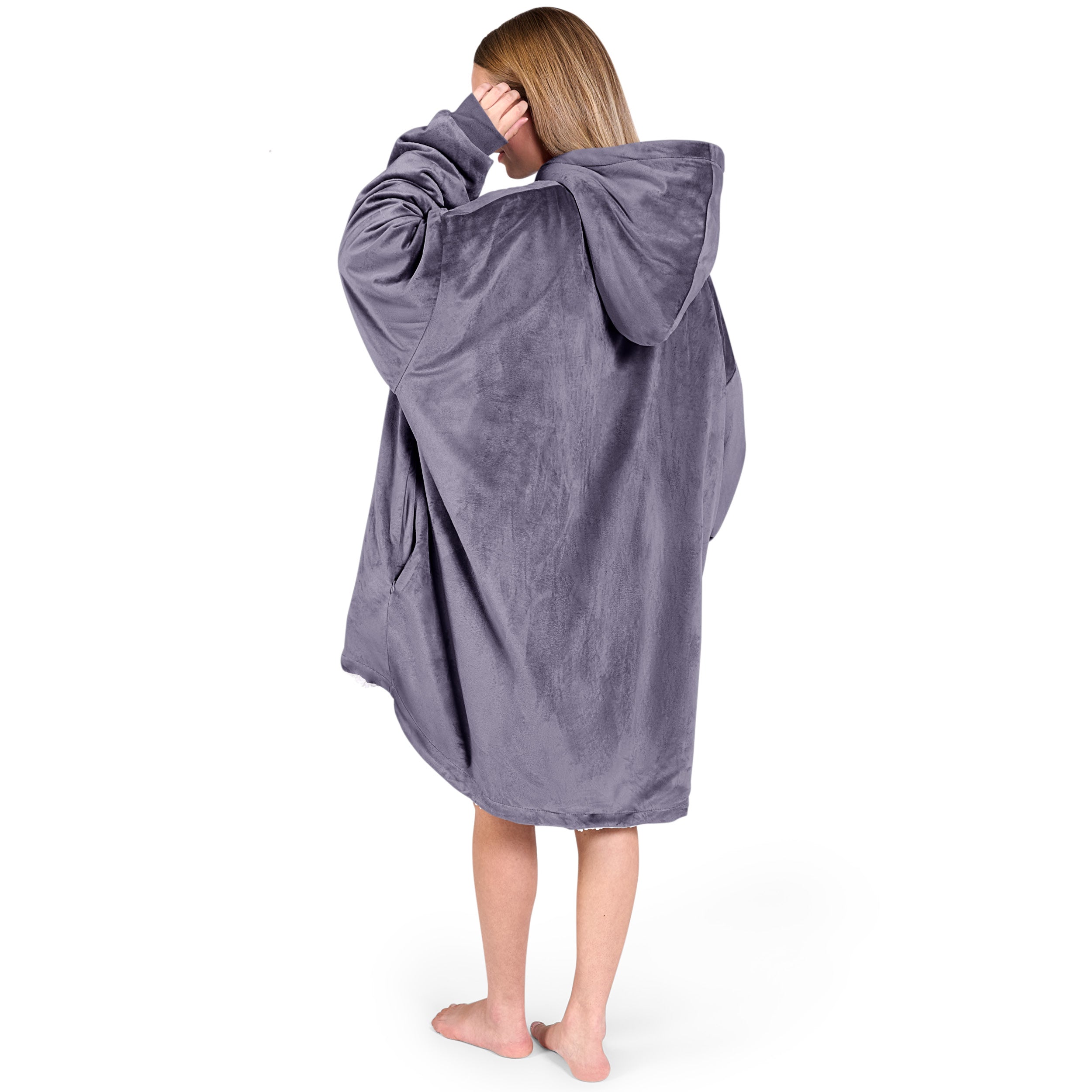 An adult with a hooded wearable blanket on