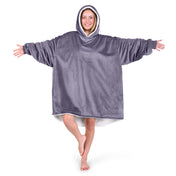 An adult with a sherpa wearable blanket on