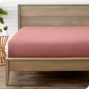 A mattress with just a fitted sheet on it