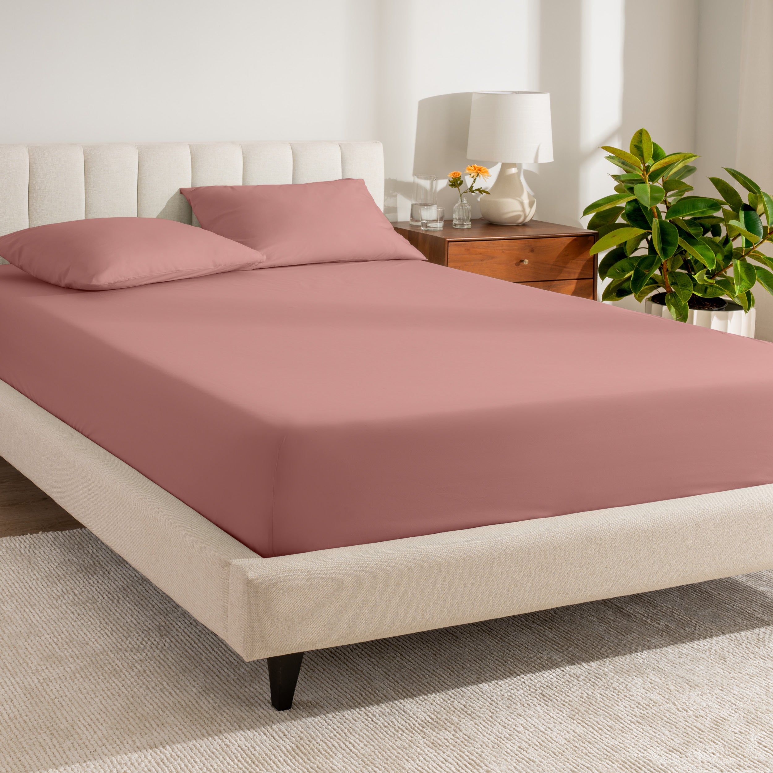 A bed made with a percale fitted sheet