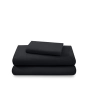 Cotton flannel sheet set folded and stacked on a white background