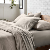 Modern bedroom with washed sheets and duvet cover on a bed