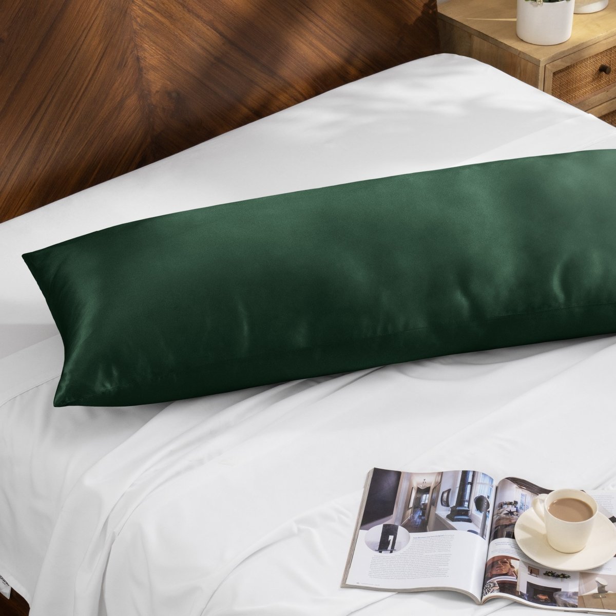 Bamboo pillow on a bed with a magazine and cup of coffee on a wooden nightstand.