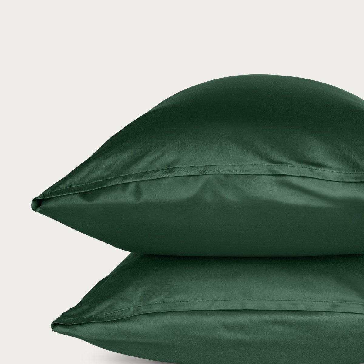 Bamboo pillowcase and bedding against a woven headboard with a plant in the corner.