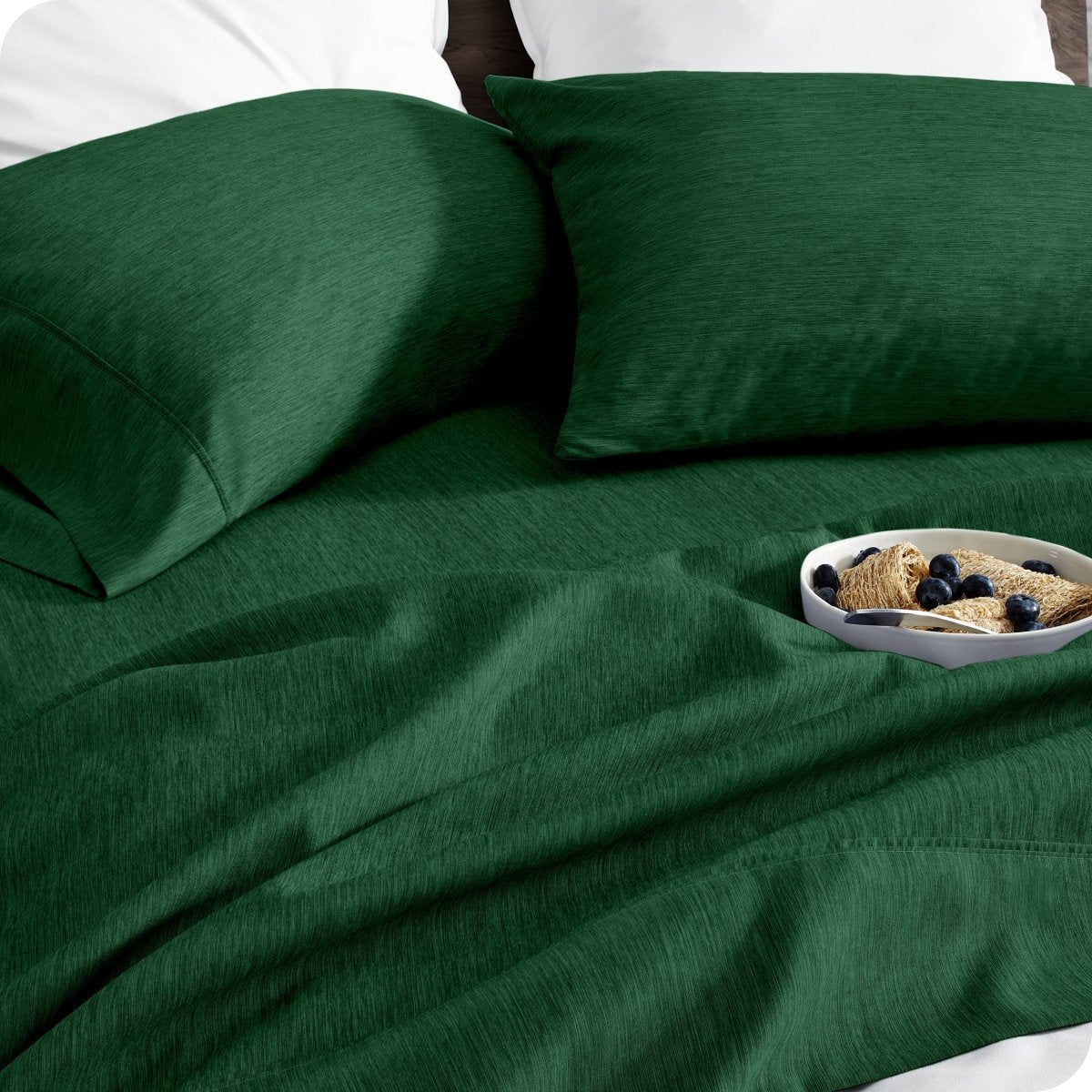 Bedding set on a bed with a bowl of cereal on a white background