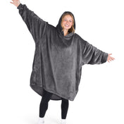A woman wearing a hooded blanket made of microplush, showcasing comfort and warmth