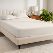 A bed made with a percale fitted sheet