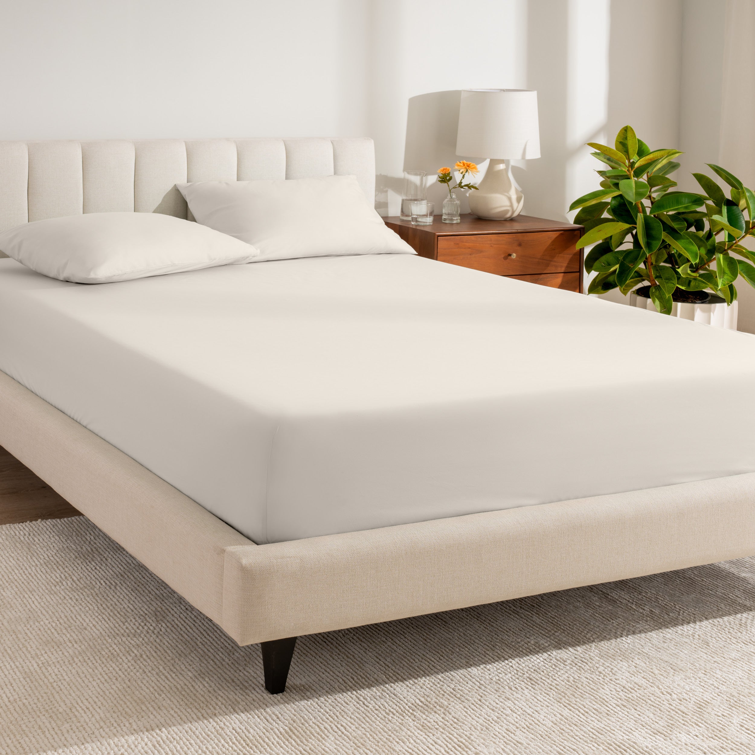 A bed made with a percale fitted sheet