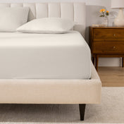 A mattress with a percale fitted sheet on it