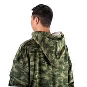 Person wearing a hooded blanket on a white background