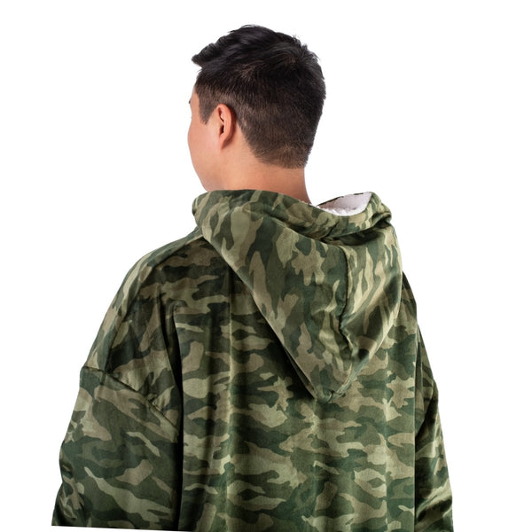 Person wearing a hooded blanket on a white background