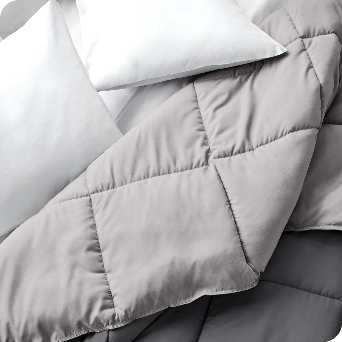Close up of a comforter folded back to show the different colored sides