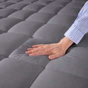 Close up of a cotton mattress pad showing the box-stitching.