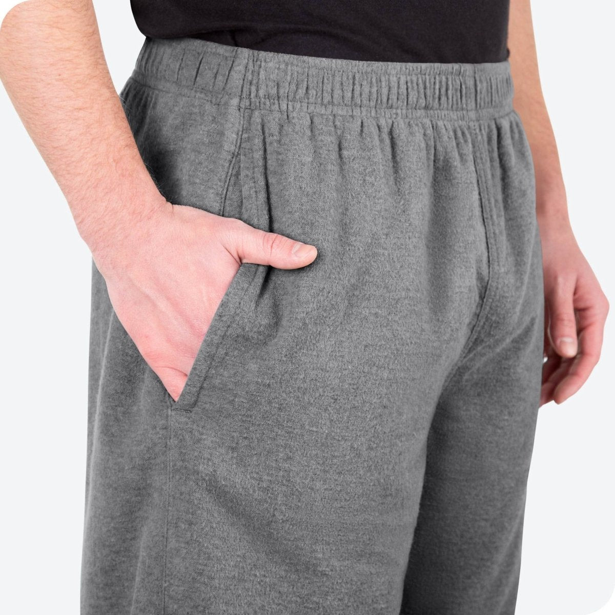 Close-up of a flannel pajama pocket with a man's hand in the pocket.