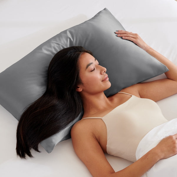 Woman lying on a grey pillow