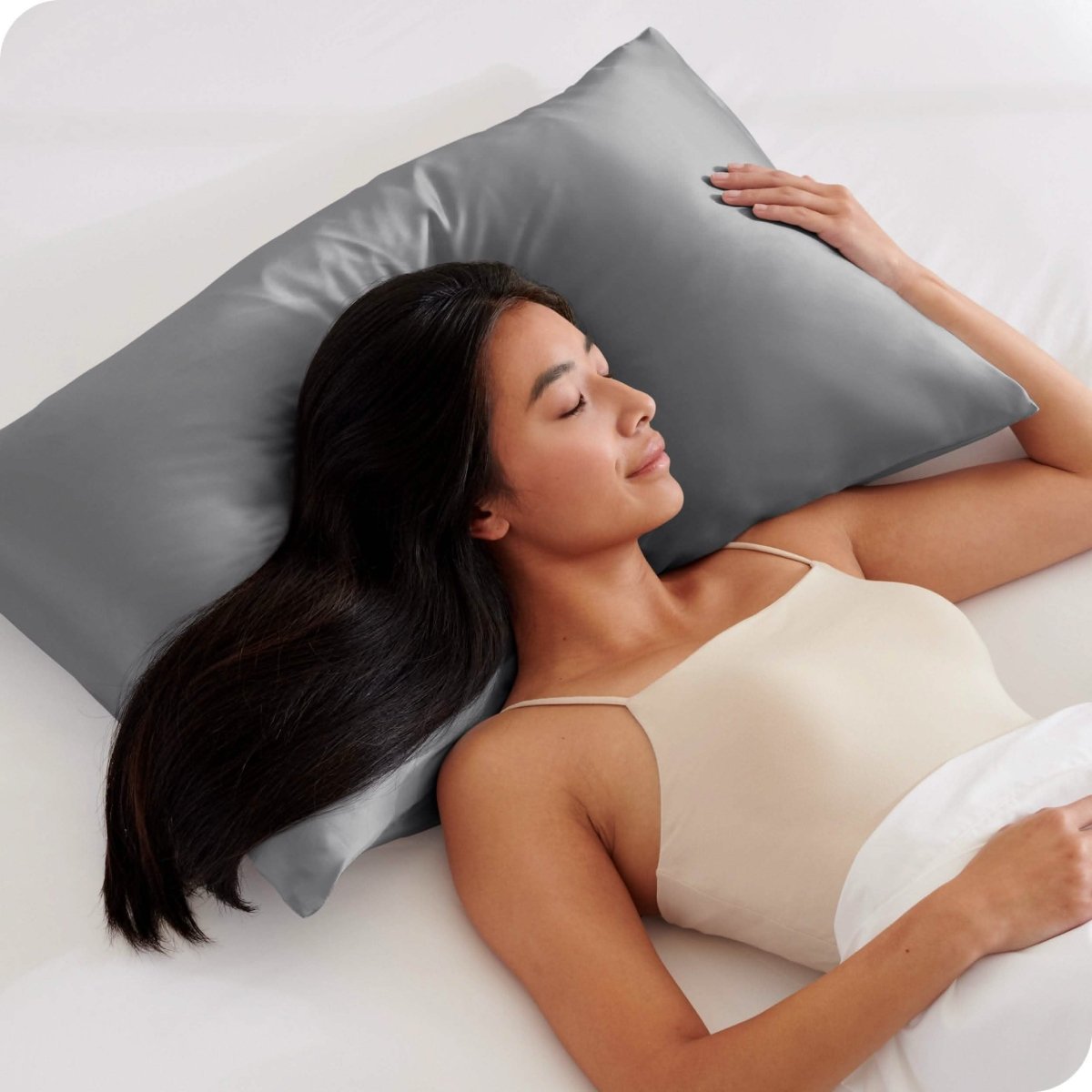 A woman sleeping with her head on a silk pillowcase