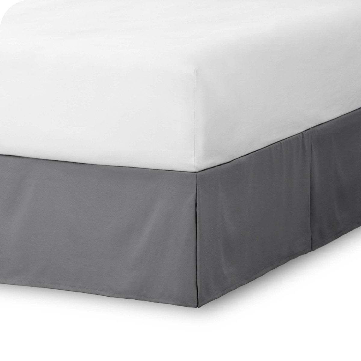 The corner of a bed skirt on a bed frame