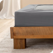 Close up of the corner of a bed frame with a cover box spring