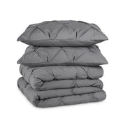 Grey pintuck comforter set folded and stacked