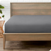 A mattress with just a fitted sheet on it
