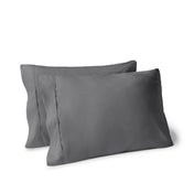 Two pillows on a white background with pillowcases on them
