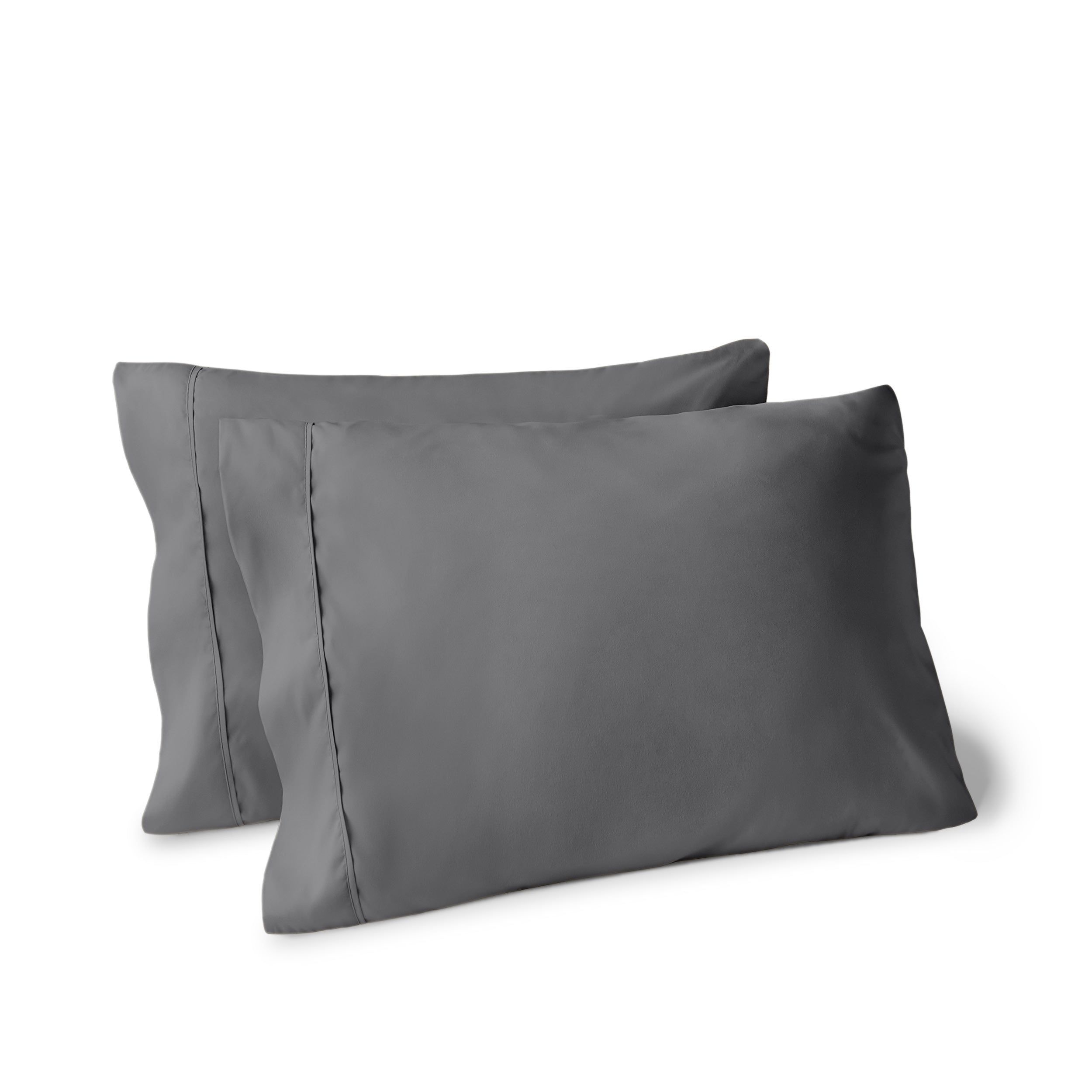 Two pillows on a white background with pillowcases on them
