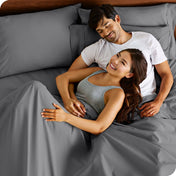 A smiling couple in bed