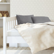 A toddler's bed with 2 microfiber pillowcases on pillows