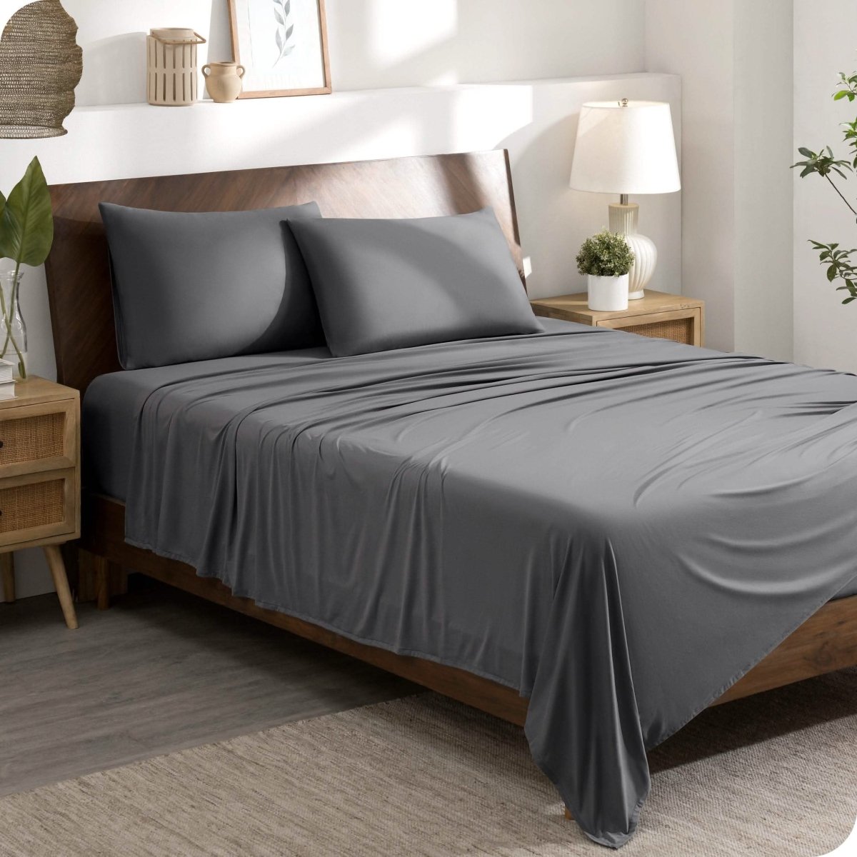 A modern bedroom set with a grey sheet set on the bed