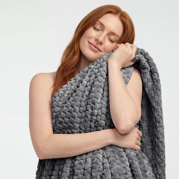 A woman holding a microplush waffle blanket