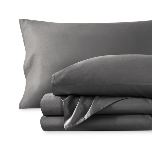 A sateen sheet set folded and stacked on a white background.