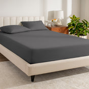 A bed made with a percale fitted sheet