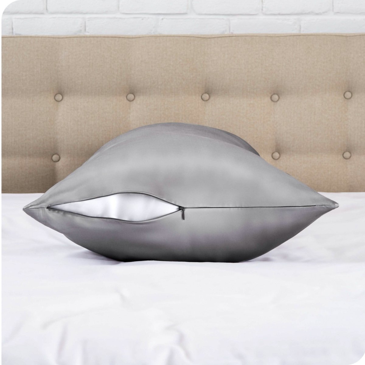 A satin body pillowcase on a bed with white linens