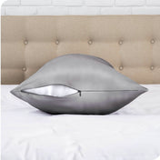 A satin body pillowcase on a bed with white linens